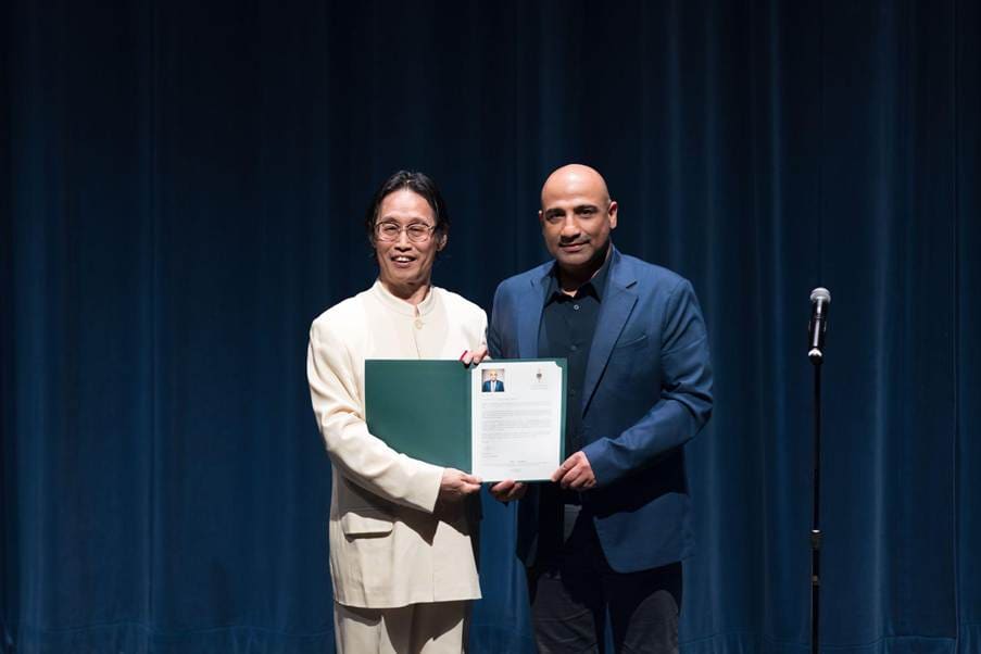 YCMA founder receiving community recognition on stage